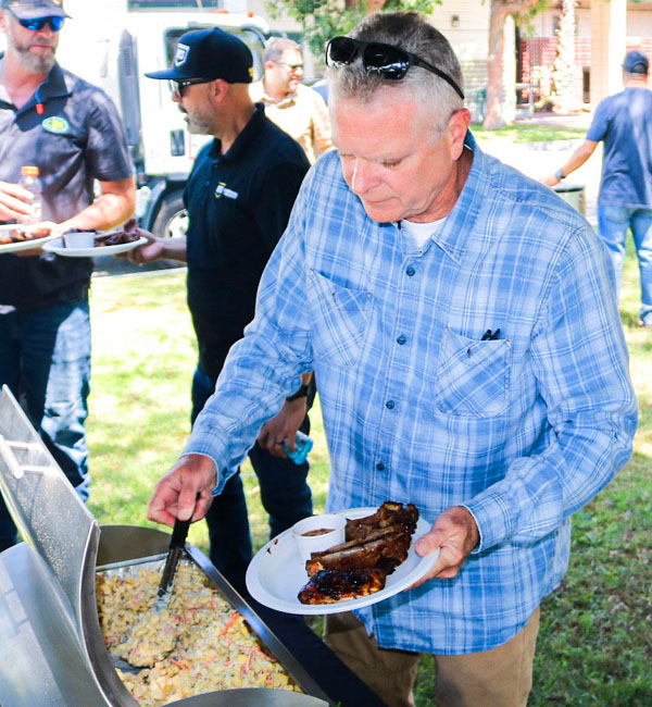 Man getting salad with ribs, catering services, Los Angeles County