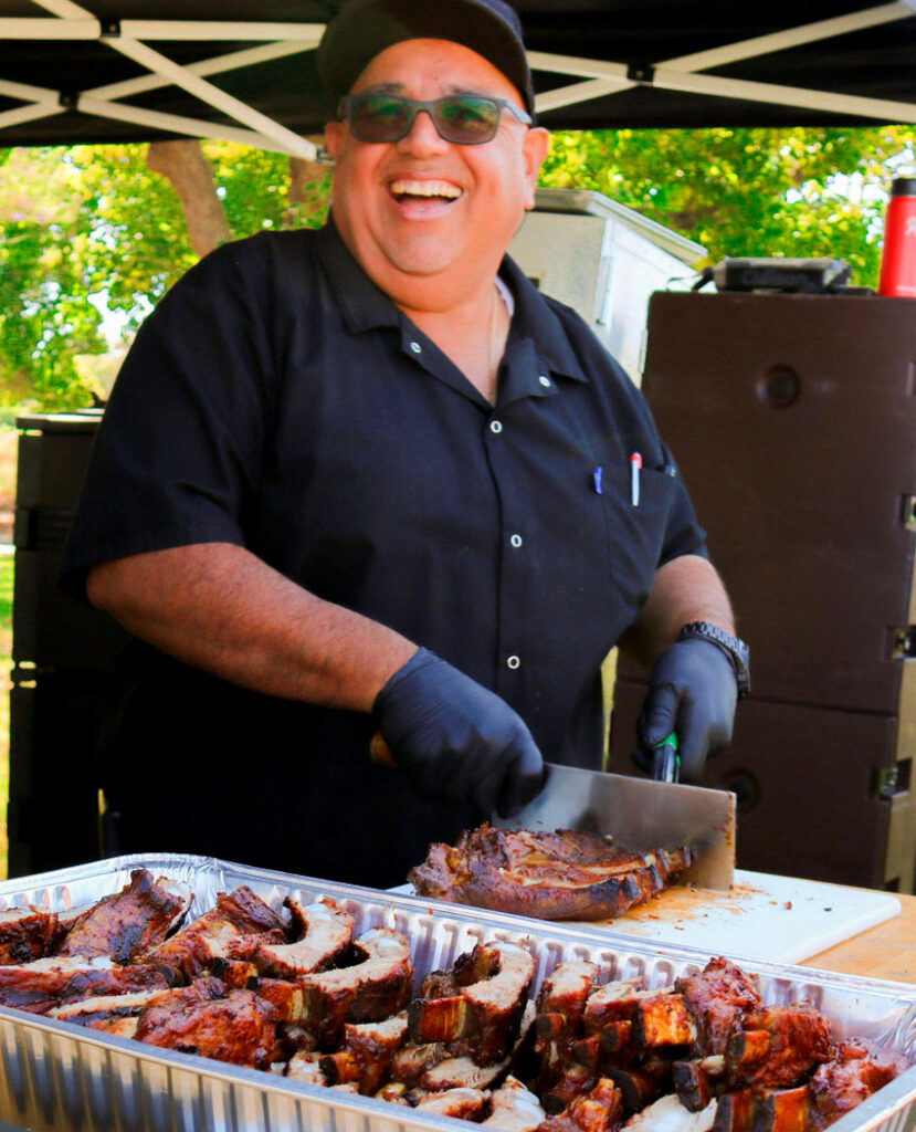William cutting ribs before serving